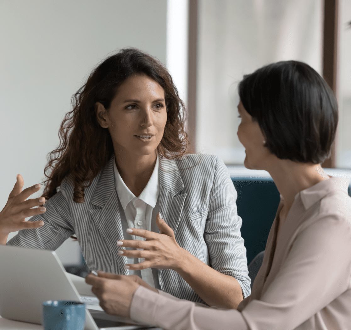 Two businesswomen discussing project ideas.